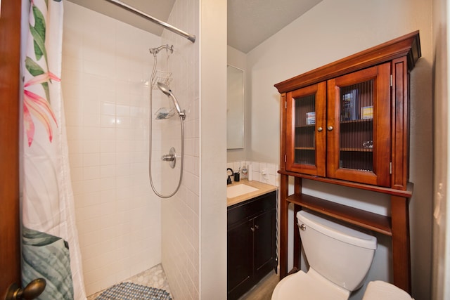 bathroom with vanity, curtained shower, and toilet