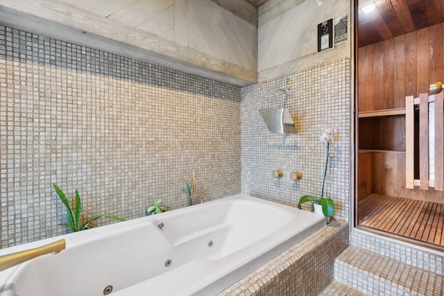 bathroom with tile patterned floors and tiled tub