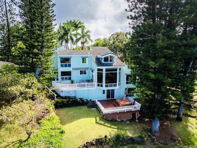 rear view of house with a lawn and a deck