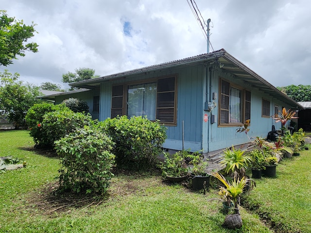 view of property exterior featuring a lawn