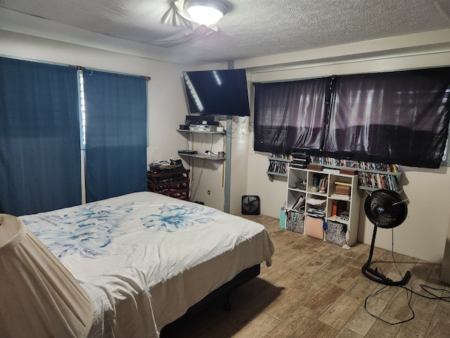 bedroom featuring wood-type flooring and a textured ceiling