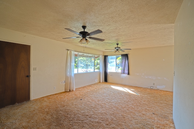 spare room with ceiling fan, carpet flooring, and a textured ceiling