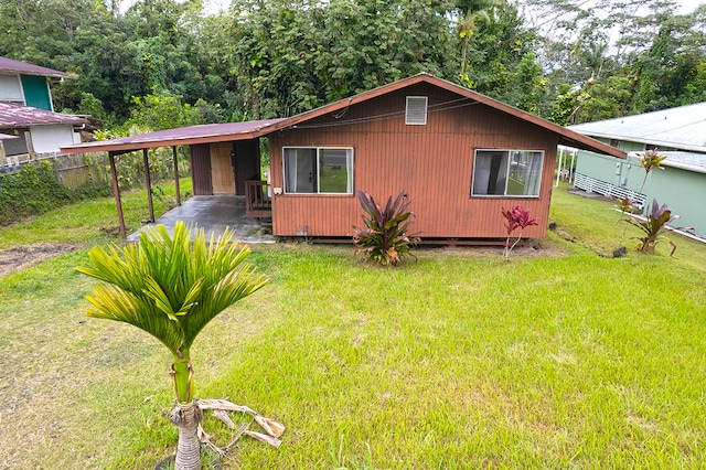 view of front of house featuring a front lawn and a carport