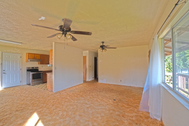 interior space with a textured ceiling, ceiling fan, and light carpet