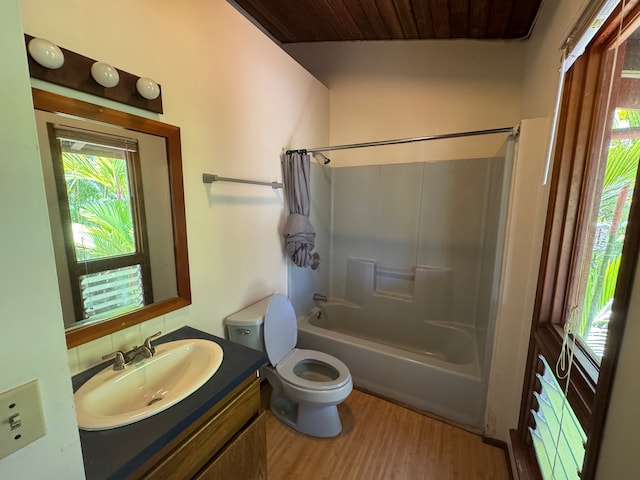 full bathroom featuring toilet, wooden ceiling, hardwood / wood-style floors, shower / bath combo with shower curtain, and vanity