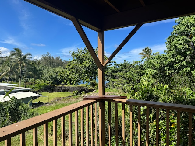 wooden deck featuring a lawn