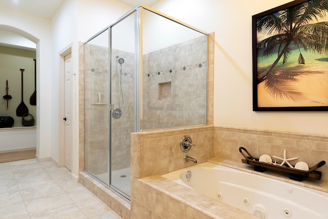 bathroom featuring shower with separate bathtub