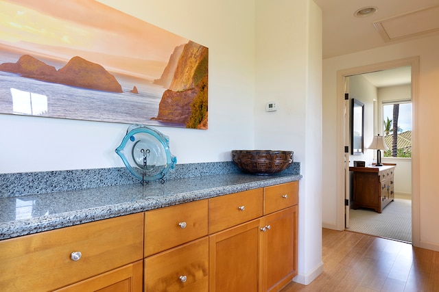 kitchen featuring light stone counters and light wood-type flooring