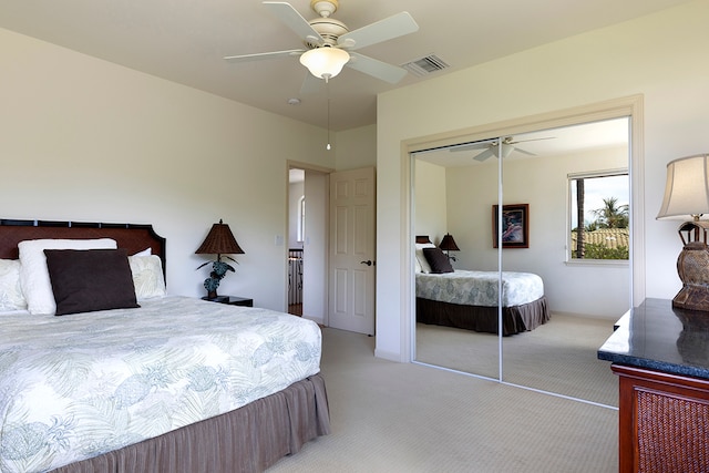 bedroom with light carpet, a closet, and ceiling fan