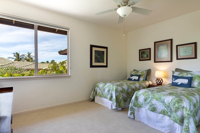 carpeted bedroom with multiple windows and ceiling fan