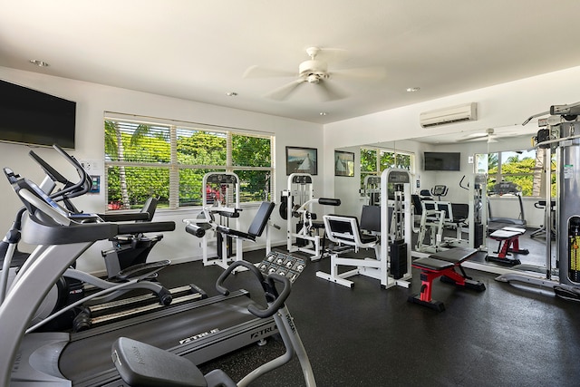 workout area featuring a wall mounted AC, plenty of natural light, and ceiling fan