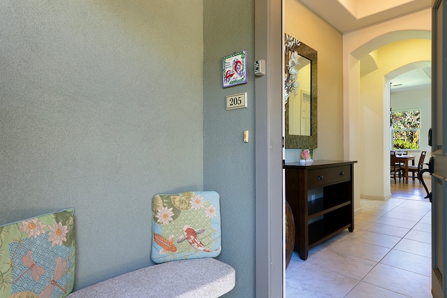 corridor featuring light tile patterned flooring