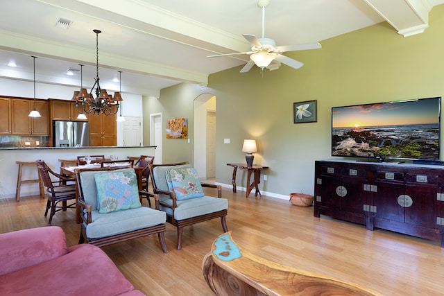 living room featuring light hardwood / wood-style flooring and ceiling fan with notable chandelier