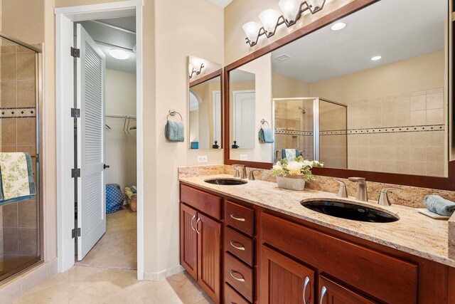 bathroom with vanity, tile patterned flooring, and an enclosed shower