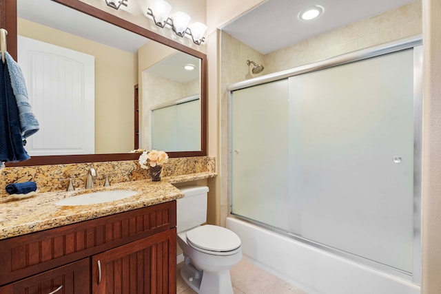 full bathroom with enclosed tub / shower combo, vanity, toilet, and tile patterned floors