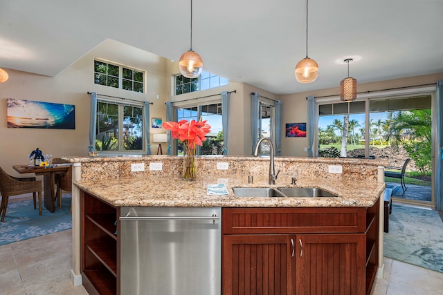 kitchen featuring pendant lighting, light stone countertops, sink, and stainless steel dishwasher