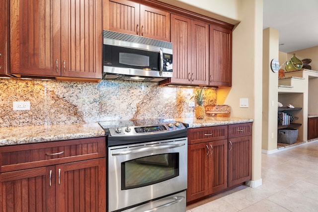 kitchen with appliances with stainless steel finishes, decorative backsplash, light stone countertops, and light tile patterned floors