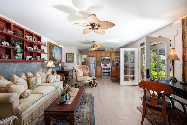 living room with ceiling fan and light hardwood / wood-style flooring