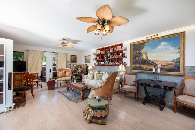 living room featuring french doors, light hardwood / wood-style floors, and ceiling fan