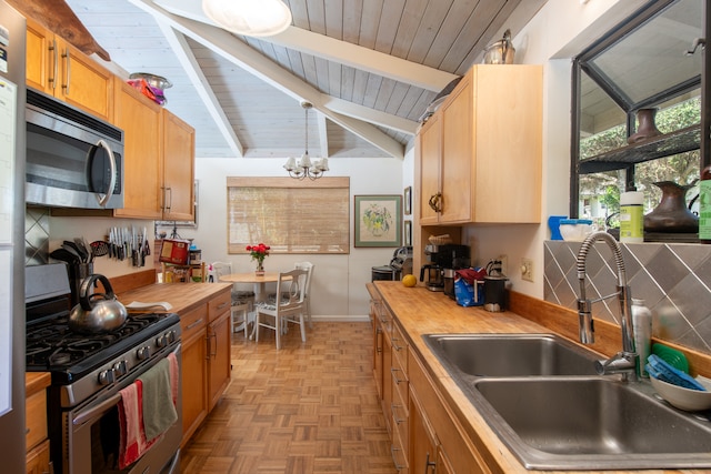 kitchen featuring light parquet floors, vaulted ceiling with beams, stainless steel appliances, wooden counters, and sink