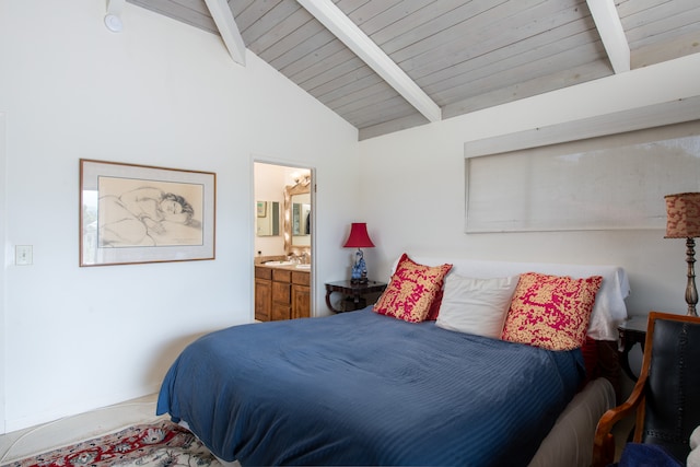 bedroom with wooden ceiling, ensuite bathroom, and vaulted ceiling with beams