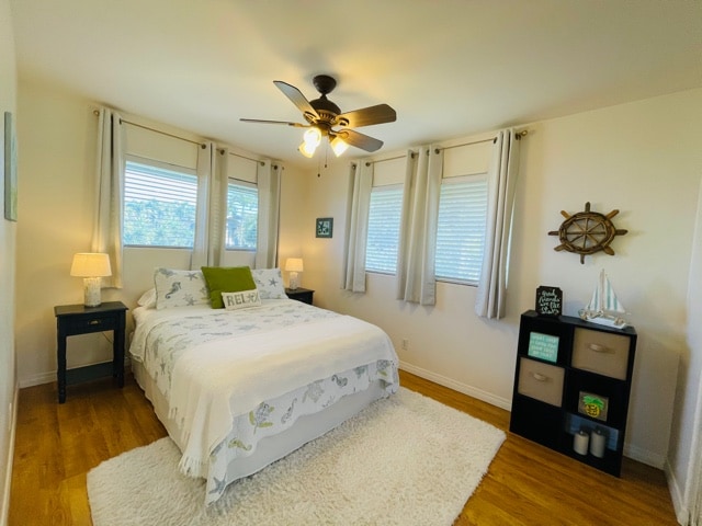 bedroom featuring ceiling fan and hardwood / wood-style floors