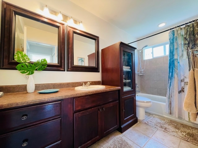 full bathroom with vanity, tile patterned flooring, shower / tub combo, and toilet