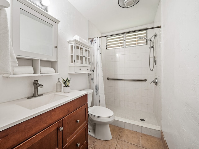 bathroom with vanity, toilet, tile patterned floors, and a shower with curtain