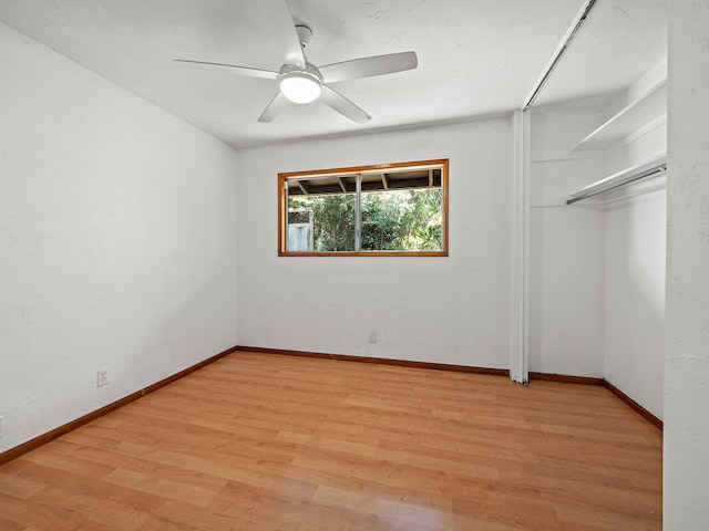 unfurnished bedroom with ceiling fan, a closet, and light hardwood / wood-style floors