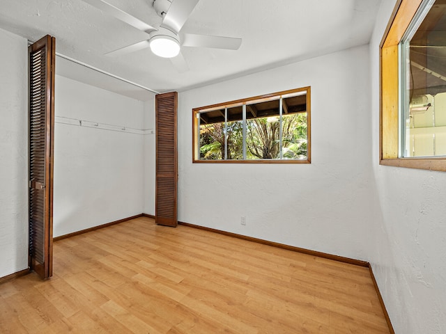 unfurnished bedroom featuring light hardwood / wood-style flooring, a closet, and ceiling fan