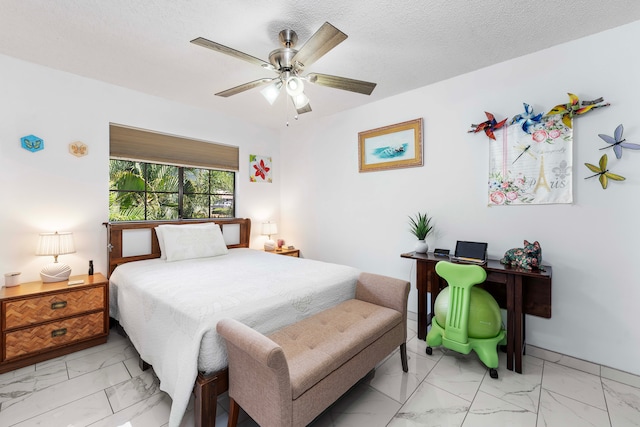 bedroom featuring ceiling fan and a textured ceiling