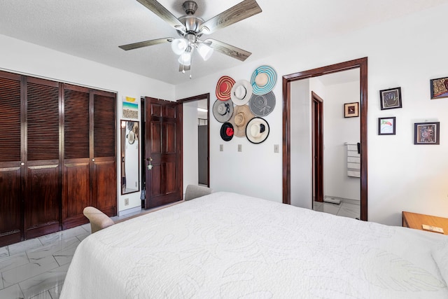 bedroom featuring a textured ceiling and ceiling fan