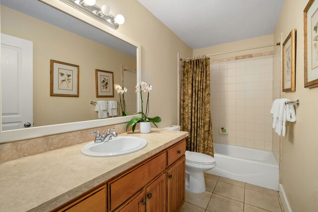 full bathroom with shower / tub combo with curtain, vanity, toilet, and tile patterned floors