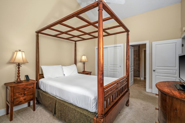 carpeted bedroom featuring a closet and a towering ceiling