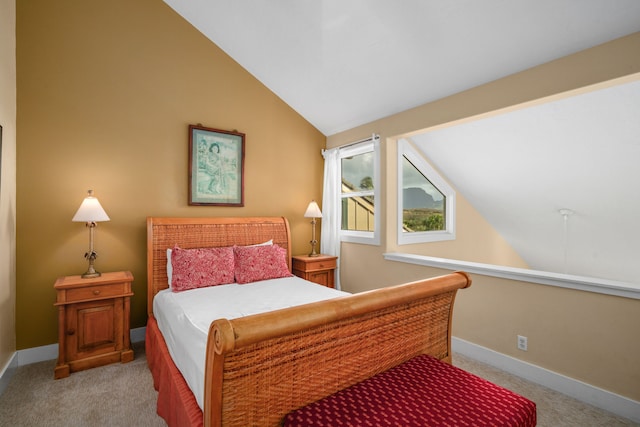 carpeted bedroom featuring lofted ceiling