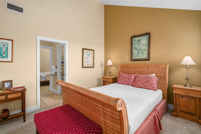 carpeted bedroom with high vaulted ceiling