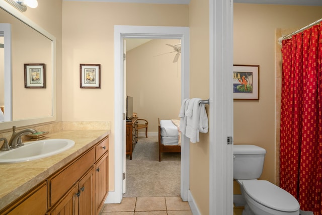 bathroom featuring tile patterned flooring, vanity, ceiling fan, and toilet