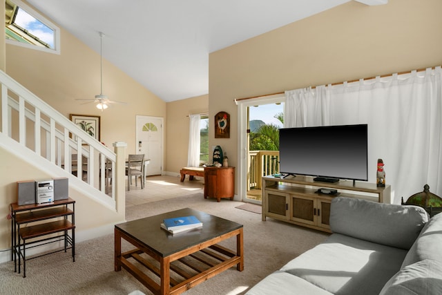 living room with high vaulted ceiling, light colored carpet, and ceiling fan