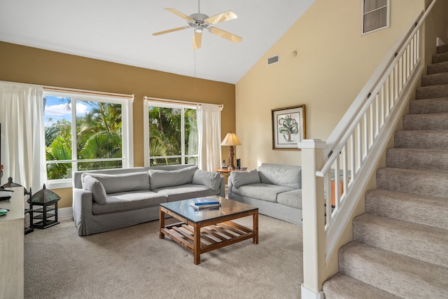 living room with ceiling fan, light colored carpet, and high vaulted ceiling