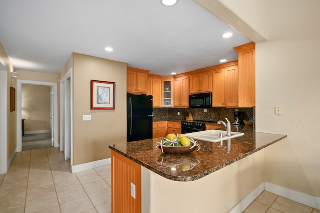 kitchen with black appliances, tasteful backsplash, dark stone counters, sink, and kitchen peninsula