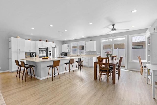 dining area featuring ceiling fan and light hardwood / wood-style flooring