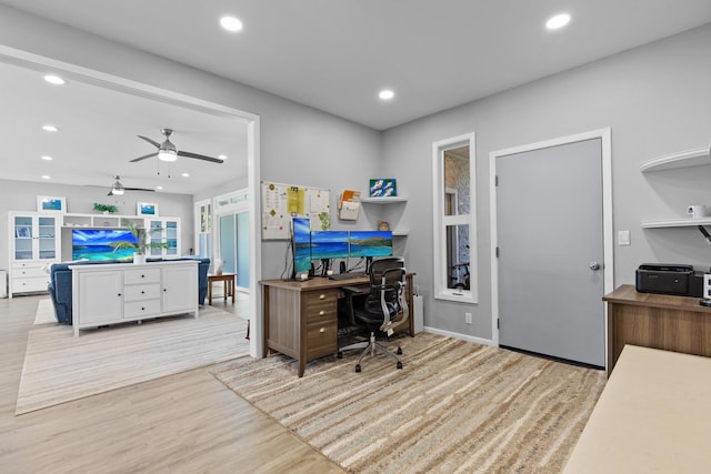 office with ceiling fan and light hardwood / wood-style floors