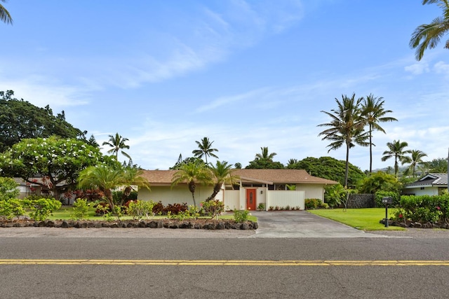 view of front of house with a garage and a front lawn