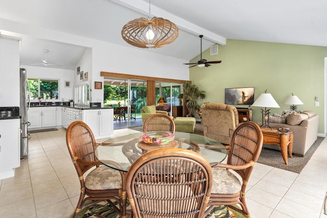 dining space with light tile patterned floors, beam ceiling, sink, and ceiling fan