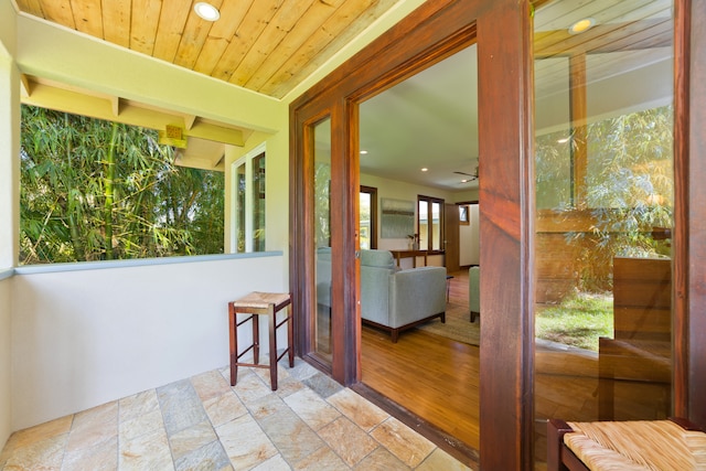 sunroom / solarium featuring wooden ceiling