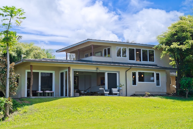 back of house featuring an outdoor hangout area, a yard, and a patio area