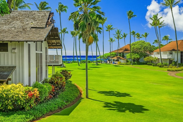 view of community with a water view and a yard