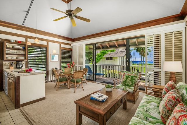 sunroom featuring a healthy amount of sunlight, vaulted ceiling, sink, and ceiling fan