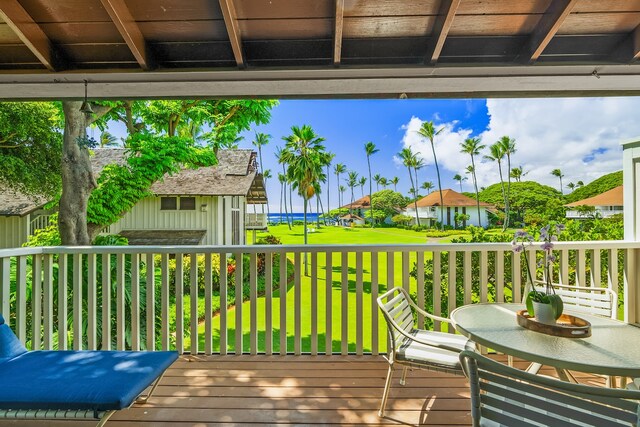 wooden terrace featuring a yard