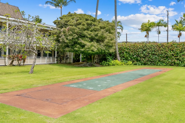 view of home's community with a yard